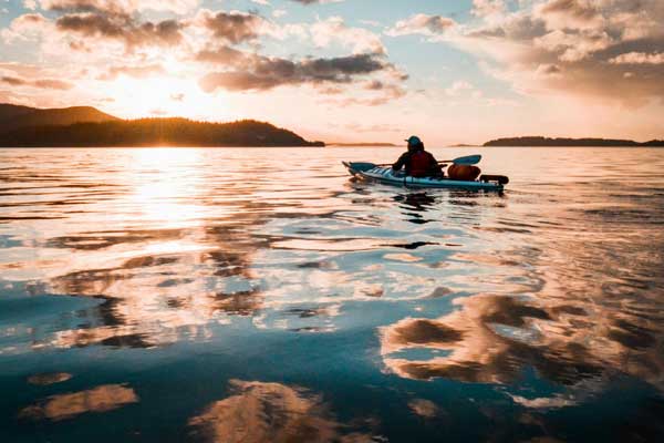 Kayaker at sunset among islands off Vancouver Island British Columbia